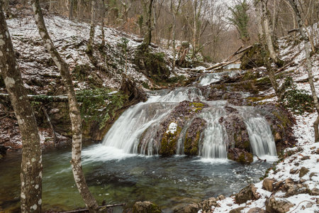 Cascades of Djur-Djur waterfall on Ulu-Uzen river in early spring with snow. Khapkhalskiy canyon in Crimeaの写真素材