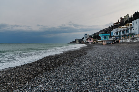 Deserted beach of Black sea in cloudy weather at early spring. Alushta. Crimeaの写真素材