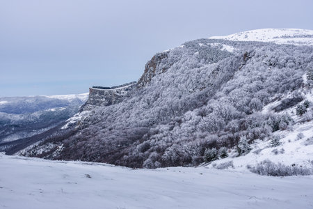 View on Visor rock on Demerdzhi mountain range in snow a early spring. Crimeaの写真素材
