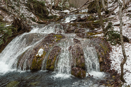 Cascades of Djur-Djur waterfall on Ulu-Uzen river in early spring with snow. Khapkhalskiy canyon in Crimeaの写真素材