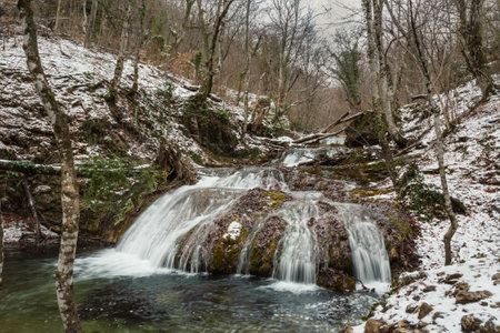 Cascades of Djur-Djur waterfall on Ulu-Uzen river in early spring with snow. Khapkhalskiy canyon in Crimeaの写真素材