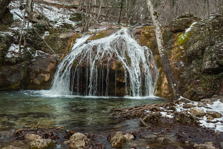 Cascades of Djur-Djur waterfall on Ulu-Uzen river in early spring with snow. Khapkhalskiy canyon in Crimeaの写真素材