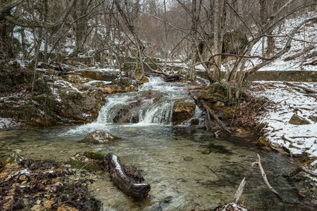 Cascades of Djur-Djur waterfall on Ulu-Uzen river in early spring with snow. Khapkhalskiy canyon in Crimeaの写真素材