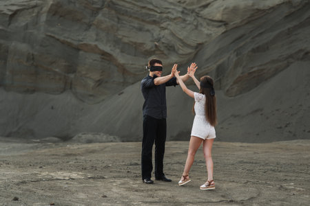 Romantic couple blindfolded with black ribbon dancing outdoors. love blind conceptの写真素材