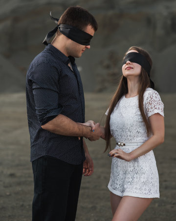 Romantic couple blindfolded with black ribbon outdoors. love blind conceptの写真素材