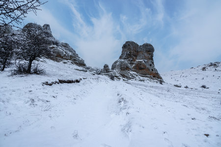 Siamese twins cliff Southern Demerdzhi in snow and ice in early spring. Crimeaの写真素材