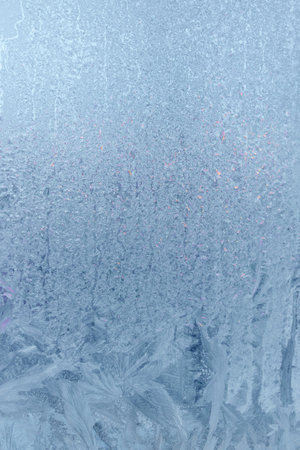 Frozen window, frost drawing on glass in cold winter. ice textureの写真素材