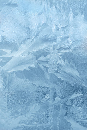 Frozen window, frost drawing on glass in cold winter. ice textureの写真素材
