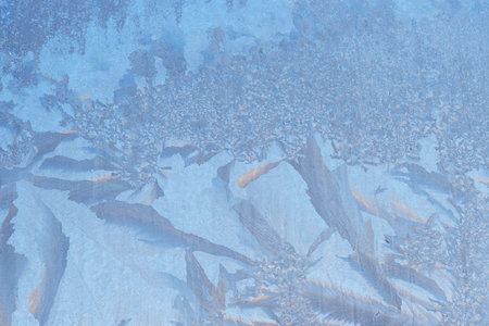 Frozen window, frost drawing on glass in cold winter. ice textureの写真素材