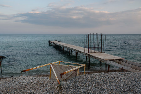 Wooden pier with closed iron gates in blue sea in spring. Koktebel. Crimeaの写真素材