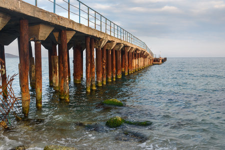Old rusty pier in blue sea in spring. Koktebel. Crimeaの写真素材