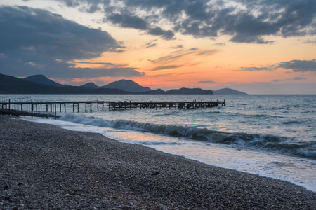 Wooden pier in the sea at sunrise in spring. Koktebel. Crimeaの写真素材