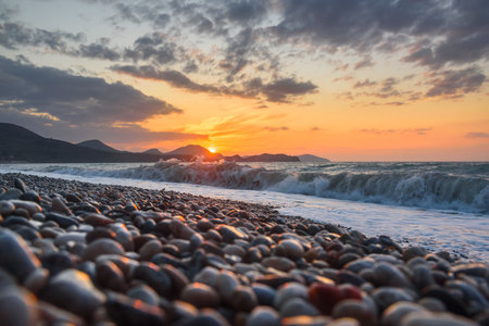 Sea coast with stones at sunrise. Beach of Black sea in Koktebel. crimeaの写真素材