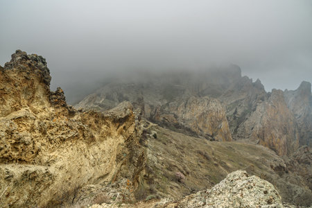 Dead city in fog and clouds. Khoba-Tele Ridge of Karadag Reserve in early spring. Crimeaの写真素材