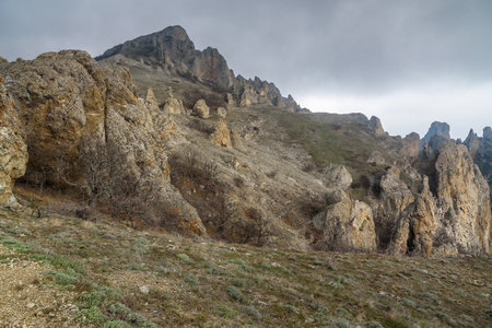 Rocks in Dead city in fog and clouds. Khoba-Tele Ridge of Karadag Reserve in early spring. Crimeaの写真素材