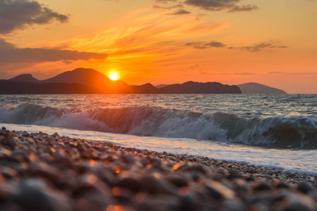 Sea coast with stones at sunrise. Beach of Black sea in Koktebel. crimeaの写真素材