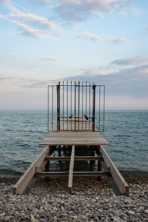 Wooden pier with closed iron gates in blue sea in spring. Koktebel. Crimeaの写真素材