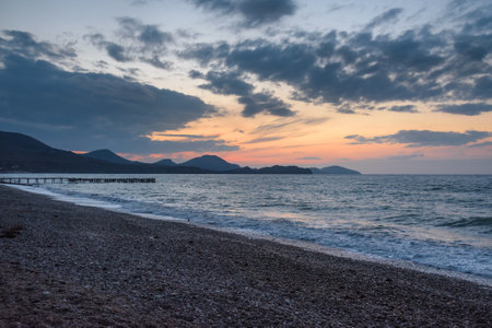 Wooden pier in the sea at sunrise in spring. Koktebel. Crimeaの写真素材