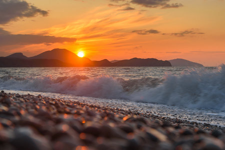 Sea coast with stones at sunrise. Beach of Black sea in Koktebel. crimeaの写真素材