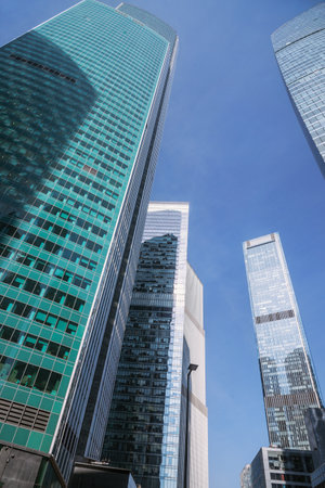 Upward view of modern skyscrapers in business center of Moscow City on blue background. Moscow. Russiaの写真素材