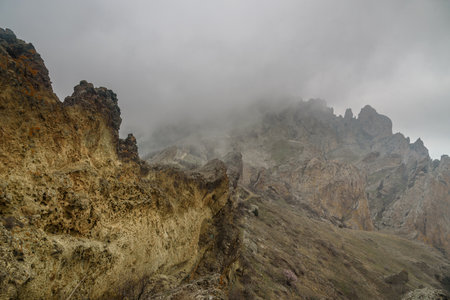 Dead city in fog and clouds. Khoba-Tele Ridge of Karadag Reserve in early spring. Crimeaの写真素材