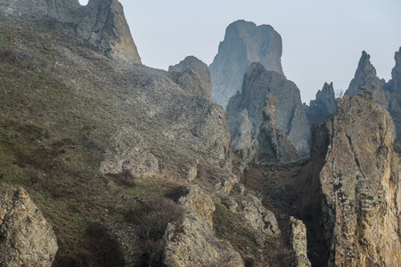 Rocks in Dead city in fog and clouds. Khoba-Tele Ridge of Karadag Reserve in early spring. Crimeaの写真素材