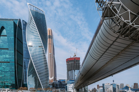 Pedestrian Bridge Bagration on Moscow river with skyscrapers Moscow City on the background in Moscow. Russiaの写真素材