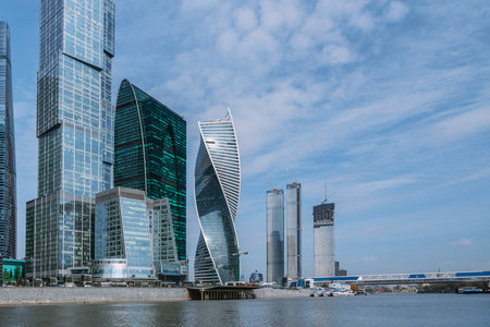 View of Skyscrapers of Moscow City district and pedestrian Bridge Bagration across the river in sunny spring day. Moscow. Russiaの写真素材