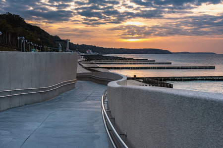 View of the promenade on the beach of the Baltic sea in Svetlogorsk at sunset. Kaliningrad region. Russiaの写真素材