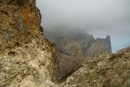 Dead city in fog and clouds. Khoba-Tele Ridge of Karadag Reserve in early spring. Crimeaの写真素材