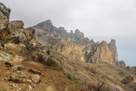 Rocks in Dead city in fog and clouds. Khoba-Tele Ridge of Karadag Reserve in early spring. Crimeaの写真素材