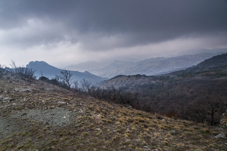 Landscape of Karadag Reserve in early spring. View of mountains in fog and clouds. Crimeaの写真素材