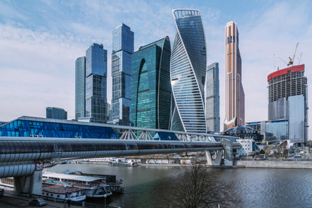Moscow, Russia - April 06, 2021: Pedestrian Bridge Bagration on Moscow river with skyscrapers Moscow City on the backgroundのeditorial素材