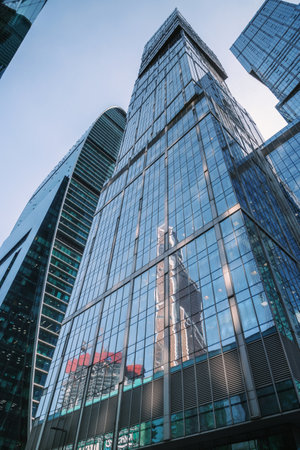 Upward view of City of Capitals skyscrapers in business center of Moscow City on blue background. Moscow. Russiaの写真素材