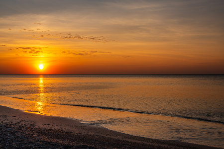 View of sandy beach with pebbles of Baltic Sea on Curonian Spit at sunset. Kaliningrad region. Russiaの写真素材
