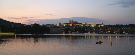 Panorama of the evening Prague with lights on. Left bank of the Vltava River near Charles Bridgeの写真素材