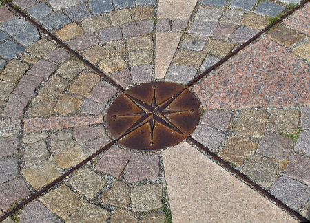 Stone pavement with a built-in metal "Rose of Wind"のeditorial素材