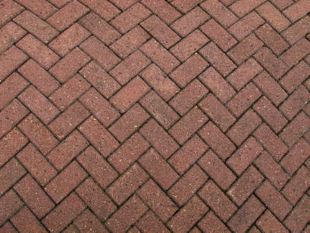 A section of the road surface lined with paving slabs of red-brown colorの写真素材