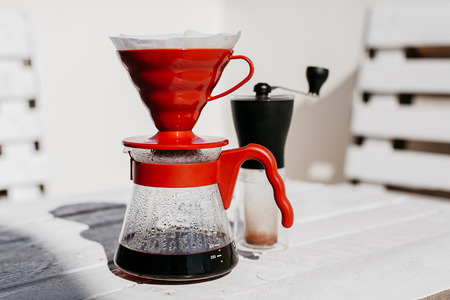 Coffee drip set with a fresh brewed coffee on wooden tableの写真素材