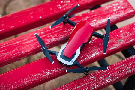 SLIEMA, MALTA - OCTOBER 16, 2018: DJI Mavic Air drone on red wooden bench. Top viewのeditorial素材