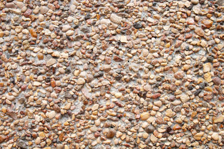 Abstract nature background. Sand texture background. Natural small brown stones. Seashore, beach. Sea pebbles.の写真素材