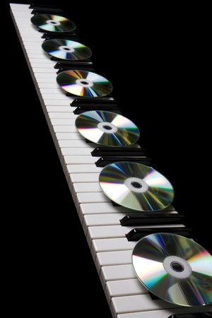 Image of the cd-drive, lying on the piano keysの写真素材