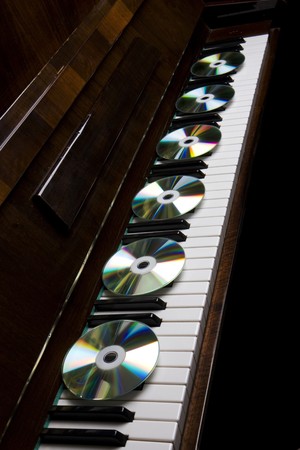 Image of the cd-drive, lying on the piano keysの写真素材