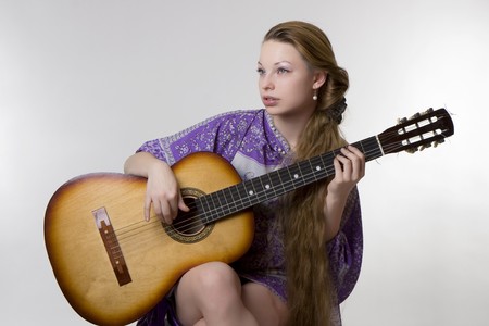 Image of a beautiful girl who plays the guitarの写真素材