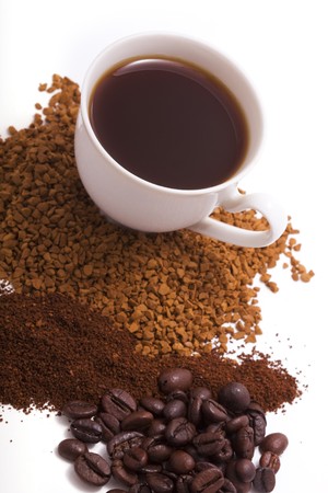 Picture of a cup of coffee, which is next to the dispersal of coffeeの写真素材