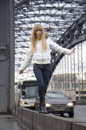 The image of a girl who walks on the background of the cityの写真素材