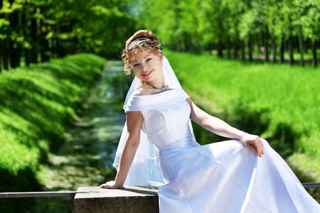 Picture of beautiful curly bride in the park.の写真素材