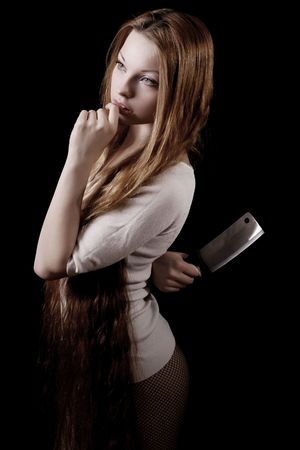 Picture of beautiful girl with a knife on a black backgroundの写真素材