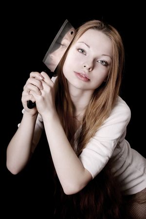 picture of beautiful girl with a knife on a black backgroundの写真素材
