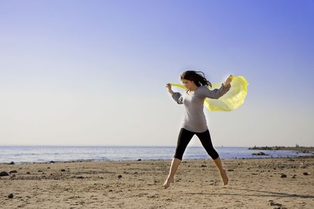The image of a beautiful brunette girl on the beachの写真素材